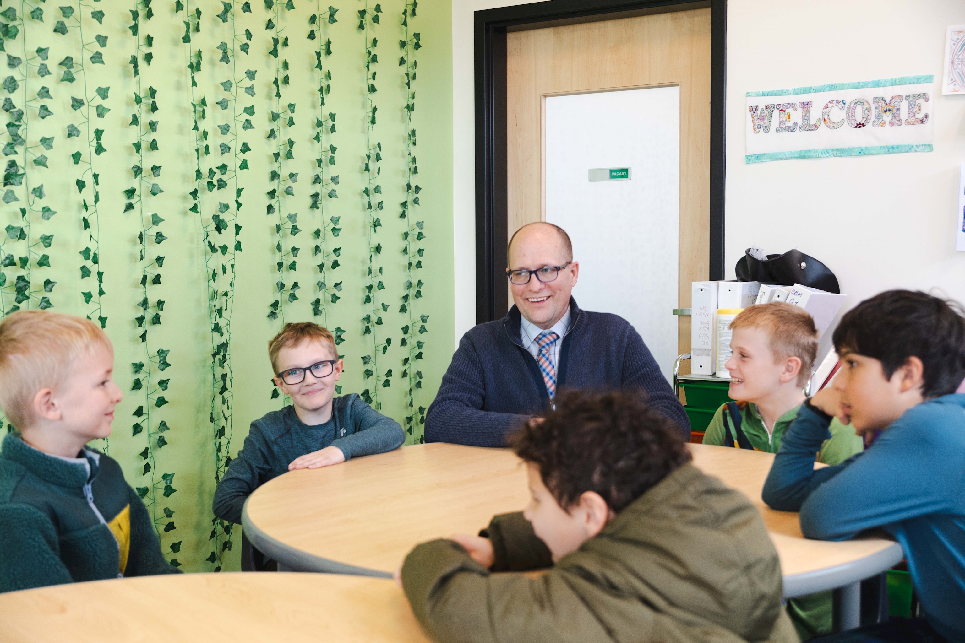 Mr. McKinnon meets with Grade 2 & 4 boys while they discuss making good choices